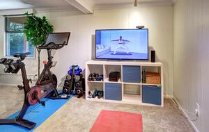 Exercise area with Peloton and smart TV