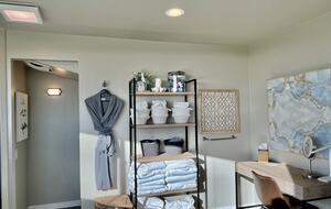 Well stocked bathroom including robes.