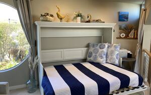 Murphy bed/desk combo open for guest use.