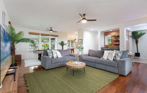 Open living room with wet bar in the back