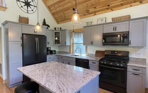 Well-appointed kitchen with pancake griddle stove.