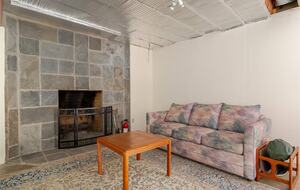 Basement game room seating and fireplace