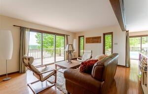 Less formal living room, open kitchen and pool to the right