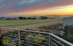 Summer sunset from primary bedroom balcony.