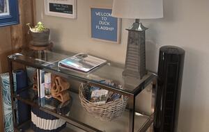 Console table with guest guide book and other reading.