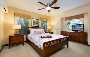 Downstairs bedroom with a queen bed