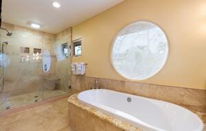 Primary bathroom soaking tub and shower area
