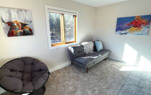 Upstairs loft area with futon and chair
