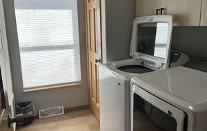 Laundry room with new washer and dryer