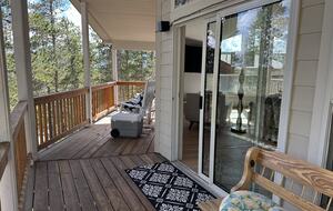 balcony off the dining room with forest views