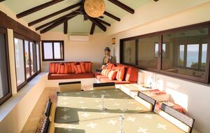 Indoor relaxation room with screened windows and A/C