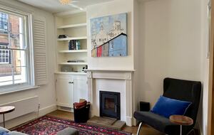 Second sitting room with original artwork and fireplace
