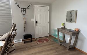 Front door with coat rack, stool, cubbies and umbrella