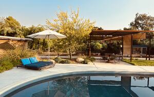 Shaded dining and lounge areas around pool