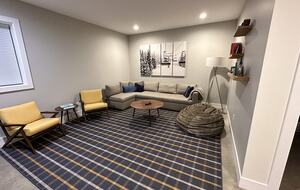 Downstairs home theater space with 72 inch TV