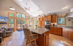 Kitchen out look heavily wooded forrest