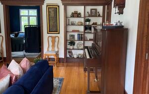 Living room closely connected to den, dining room and porch