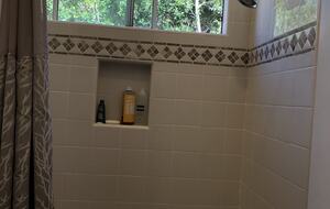 Tub shower in family suite bedroom