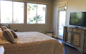 Primary bedroom with large screen TV with streaming