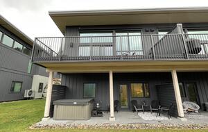 Rear of house with two decks, hot tub and yard