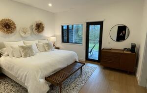 Primary bedroom with access to lower deck and hot tub