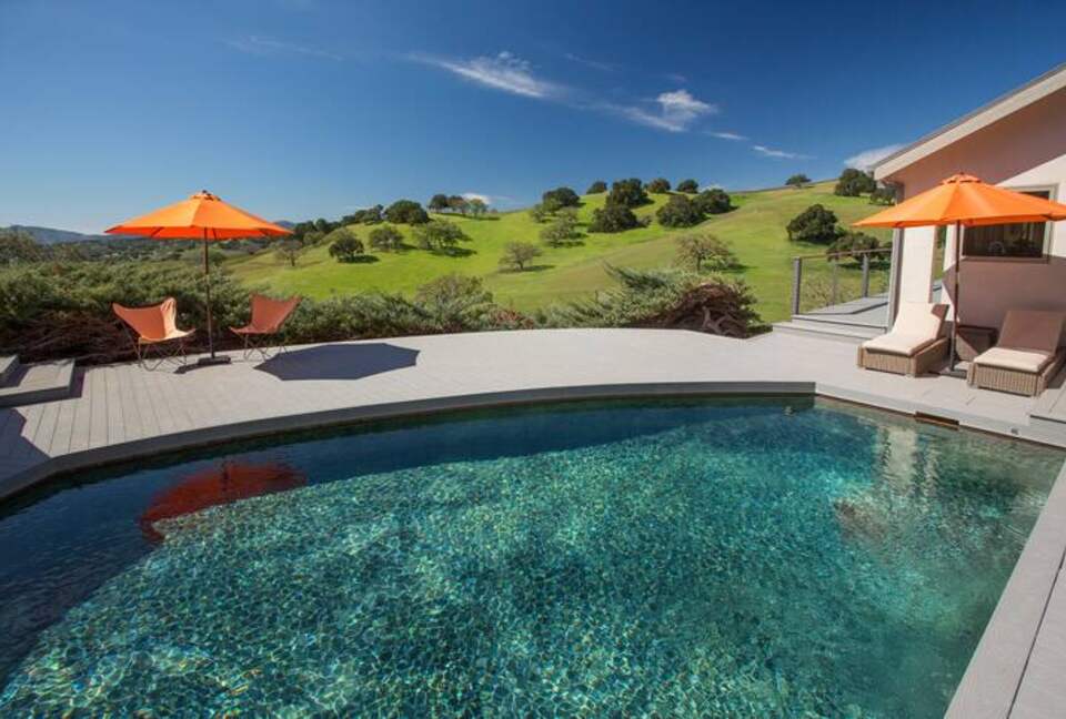 Pool and hot tub with view of the hills