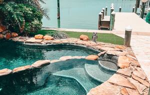 Charming Beach Cottage Steps from St. Pete Beach with Lagoon Pool & Dock - St. Pete Beach, Florida