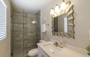 Master bathroom with single sink and walk in shower