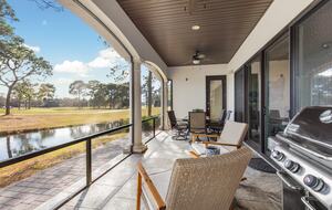 Screened patio with grill and dining area