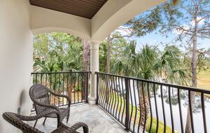 Upstairs primary bedroom with private balcony