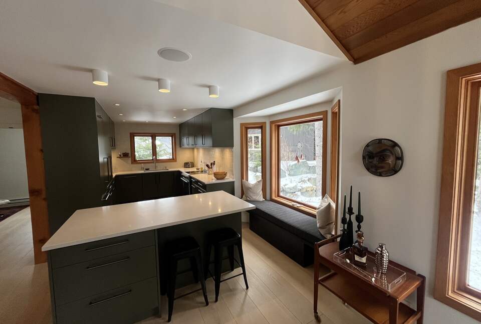 Chef’s kitchen with induction stove, dishwasher, built in fridge.