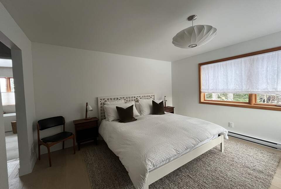 Primary bedroom with king sized bed and ensuite bath.