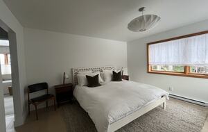 Primary bedroom with king sized bed and ensuite bath.