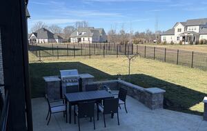 Lower patio with dining table and BBQ