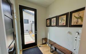 Another view of seating area by door leading to backyard. On the left