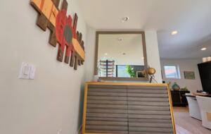 Luxury credenza with mirror above basement stairway