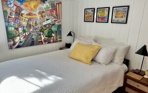 The queen bed in the Rainbow room (basement)