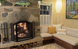 The family/TV room with a roaring fire
