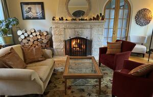 The living room with a travertine fireplace