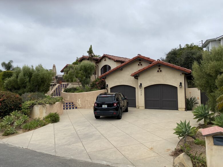 Street view; driveway holds two guest cars plus owners car on occasion