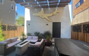 Backyard outdoor space with fire pit and hot tub