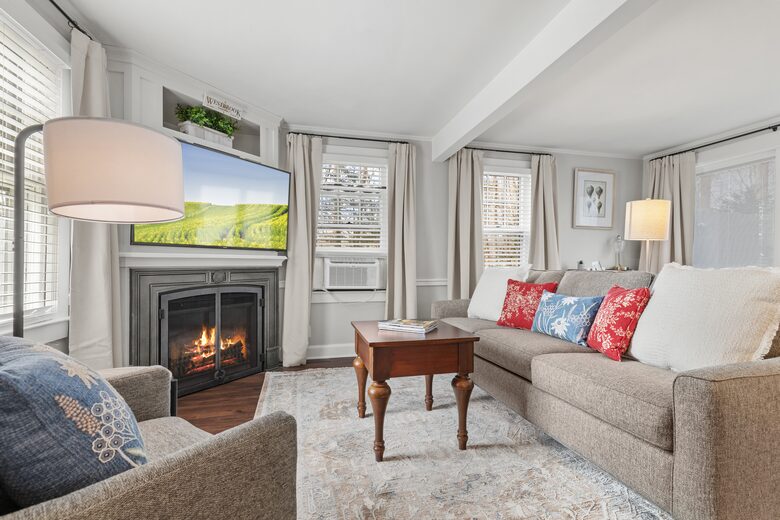 living space with large screen TV and fireplace