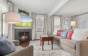 living space with large screen TV and fireplace