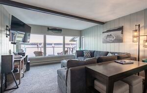 Cozy living room with a wood fireplace and views.
