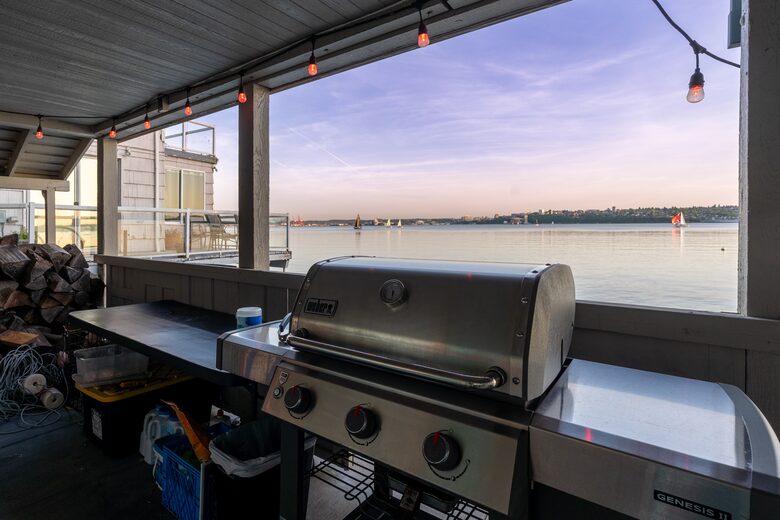 Covered BBQ area and cornhole on the lower deck.