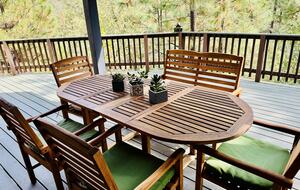 Outdoor dining area with forest views
