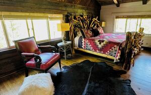 Primary bedroom on top level; custom artisan-made bed