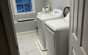 Laundry room with full-size washer dryer and ironing center