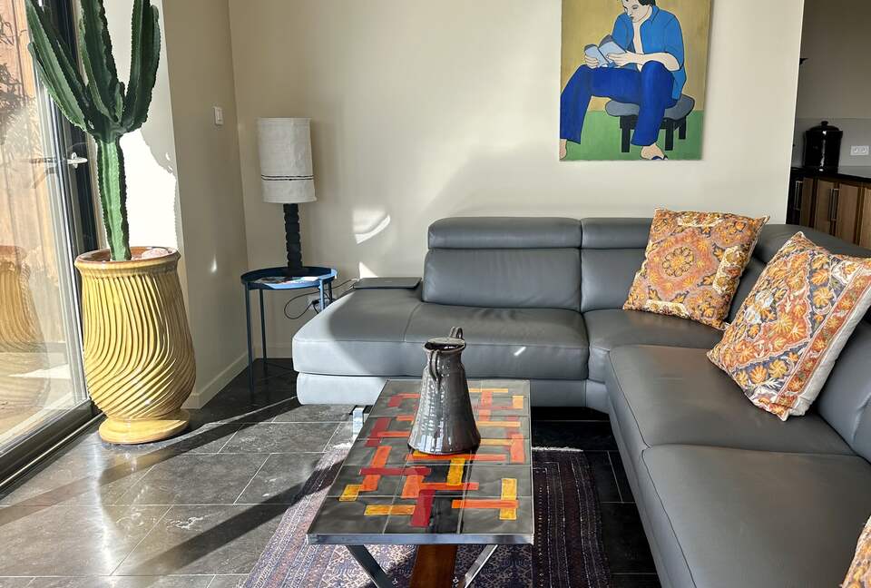 Main Upper: Open living with leather sofa