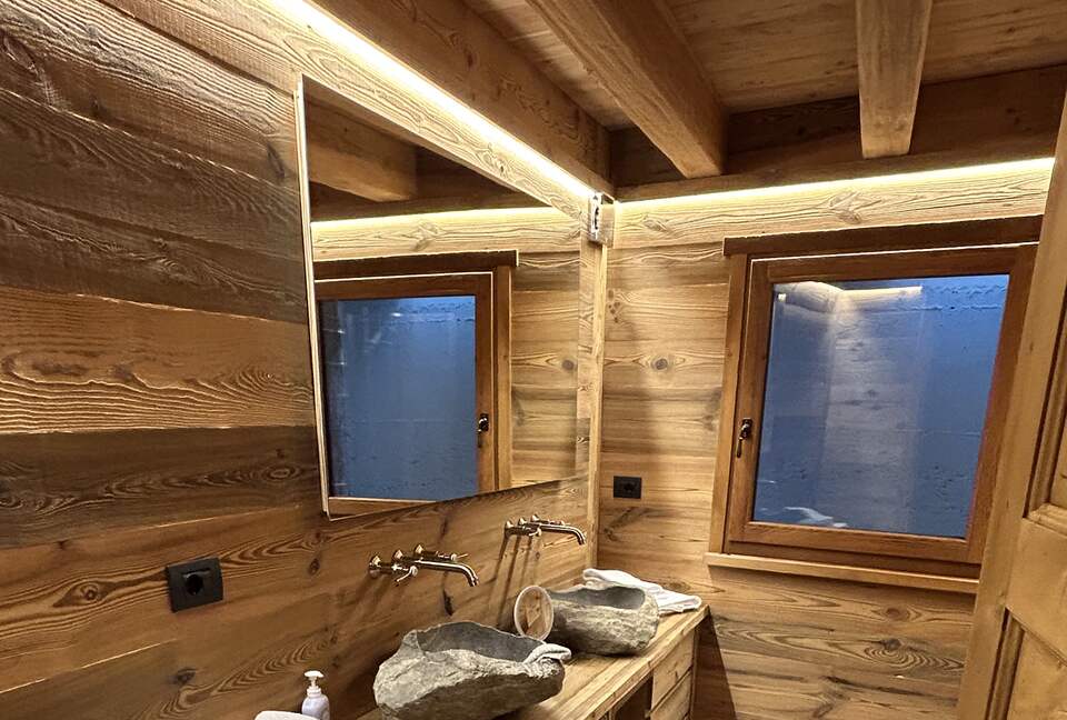 Guest bathroom with carved stone sinks and large shower